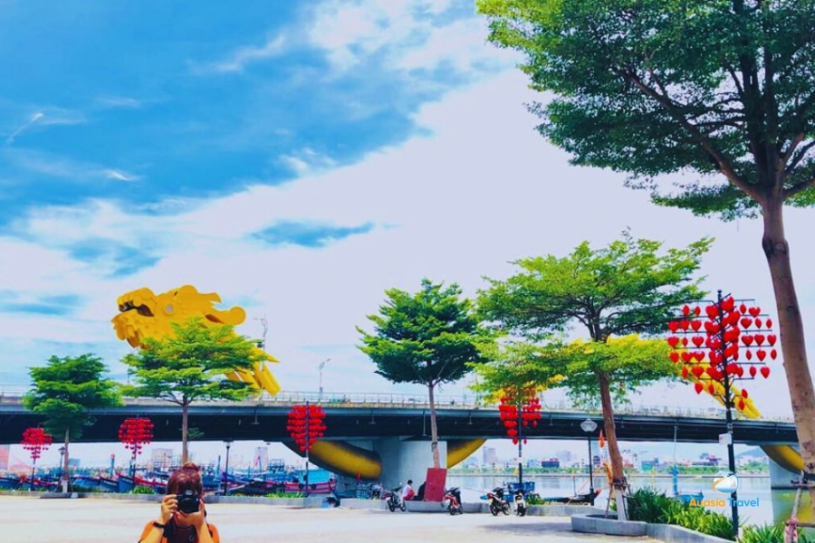 Dragon bridge in Da Nang Vietnam glowing brightly at night over the Han River